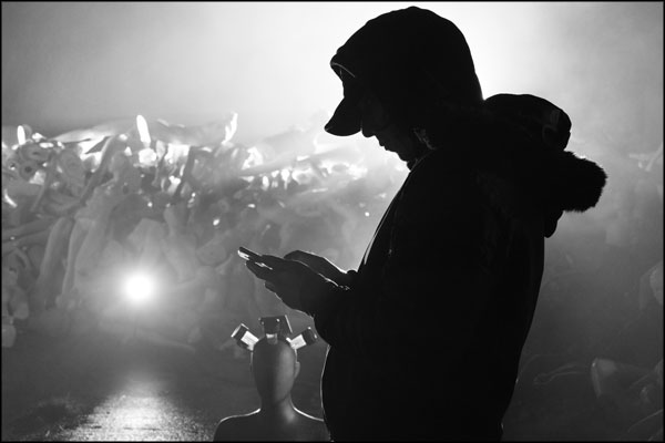 Singer, OC Precadio, in silhouette, awaits the call for the next scene. Photography by Greig Clifford