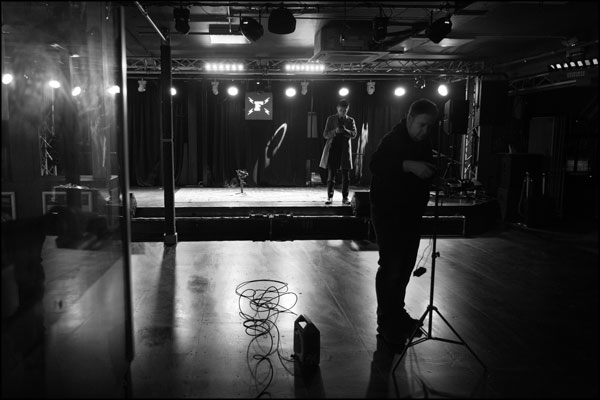 Inside the venue, lighting is set up and more lines written for the next piece to camera - photography by Greig Clifford