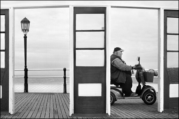 A-015. Dog in Basket with Chauffeur on a Pier - by Greig Clifford