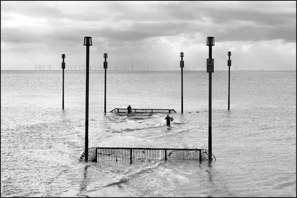 B-067. Fishing at the Southwick outfall, as rain falls upon the wind farm (2) - by Greig Clifford