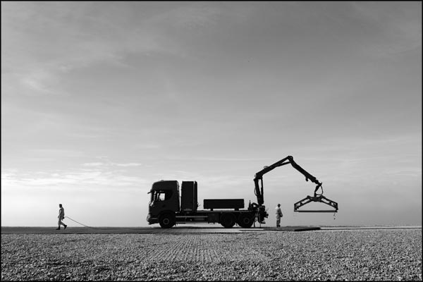 C-006. Workers On The Beach - by Greig Clifford